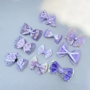 Detailed set of purple handmade bow hair clips with lace, satin fabrics and pearl beads