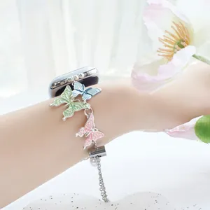 Detailed view of silver Apple Watch band with colorful enamel butterflies and pearls