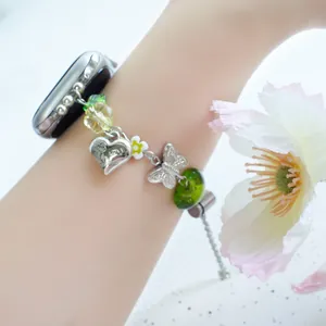 Handmade beaded green Apple Watch strap with heart charms and butterfly accents