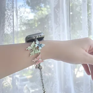 Detail of creative colorful butterfly charms on metal bracelet strap for Apple Watch