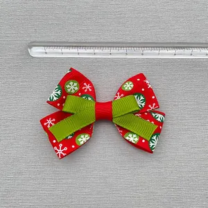 Close-up of 8cm Christmas bow hair accessory with snowflake pattern and measuring ruler