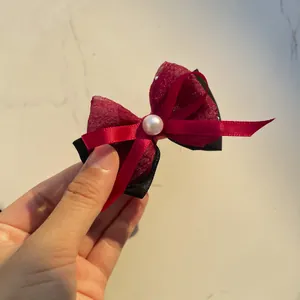 Handmade layered black and red mesh bow hairpin with a white pearl center detail