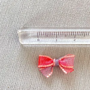 Macro detail of a 2.5cm handmade DIY mesh bow accessory with metallic thread textures