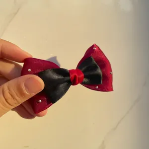 Detail of red and black satin bow accessory with silver rhinestones for DIY crafts