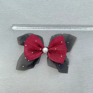 Detail of red and black double-layered bow with pearls and silver beads, 12cm wide