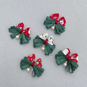 Detailed view of Christmas ribbons with festive prints and elegant pearl pendants