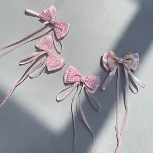 Detailed view of pink DIY bow hairclips with pearls for dolls, toys and pets accessories
