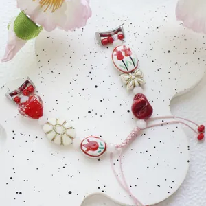Handmade beaded flower and heart strap for iWatch featuring pink braided rope and ceramic beads
