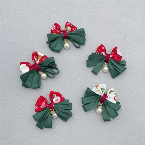Macro detail of Christmas grosgrain bows with holiday patterns and faux pearl charms