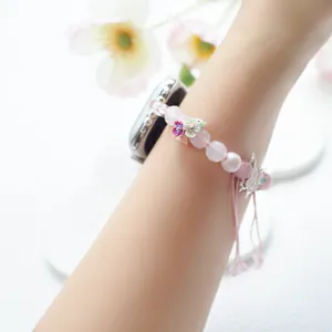 Close-up of pink crystal beads and butterfly charms on adjustable Apple Watch strap