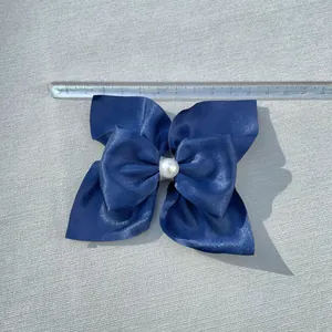 Dark blue ribbon bow hair clip with faux pearl center and a 13cm width measurement