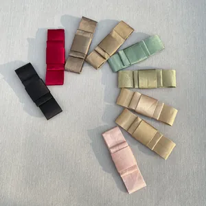Detailed overhead view of assorted satin ribbon bows in nine elegant colors for DIY crafts