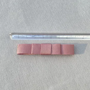 Detailed top view of a dusty pink double-layered satin ribbon bow measuring 8.2cm long