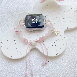Detail of pink quartz beaded watch band with silver butterfly charms and heart floral accents