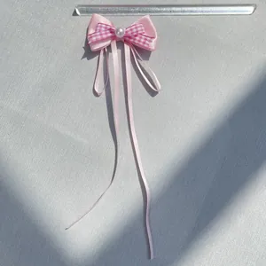 Pink satin bow hair clip with checkered layer and white pearl detail showing dimensions