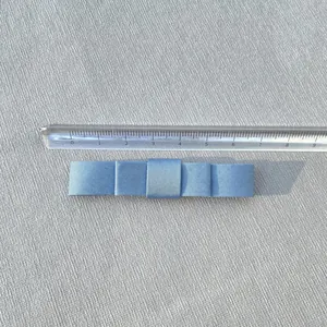 Macro view of a 7.5cm light blue double-layered satin ribbon bow with ruler scale measurement