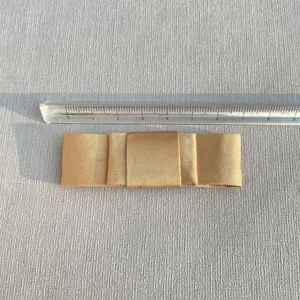 Champagne satin bow accessory measured at 8cm width for hair or garment crafts