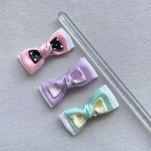 Detailed view of handmade polka dot ribbon bows with heart-shaped metal buckles
