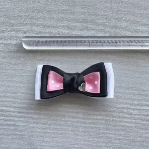 Polka dot layered ribbon bow hair accessory with heart center and measuring scale