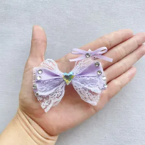 Dettaglio di fiocco in pizzo viola fatto a mano con strass a cuore per accessori fai-da-te