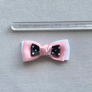 Pink and polka dot layered bow accessory with heart rhinestone, 7.5cm measurement view