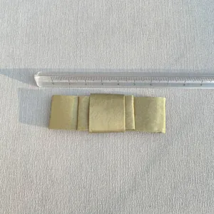 Close-up detail of champagne satin bow accessory with ruler showing 8.5cm width