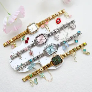 Détail de quatre montres à quartz carrées pour femmes avec cadrans colorés et breloques
