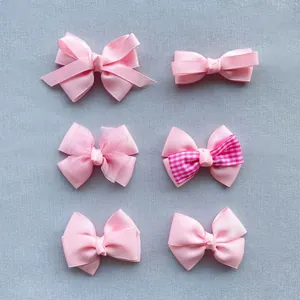Detailed view of six different pink ribbed ribbon bows with organza and plaid accents
