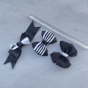 Detailed view of handmade black and white bow accessories in varied fabric textures