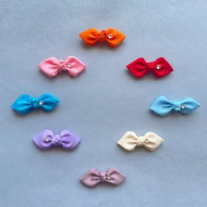 Detailed view of eight assorted colorful grosgrain ribbon bows with silver star centers