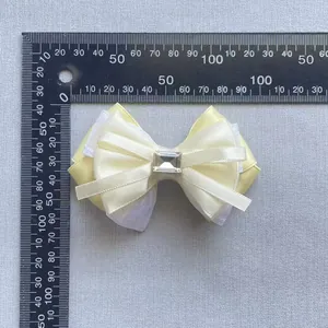 Handmade yellow and white ribbon bow with large clear crystal gemstone for hair accessory
