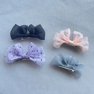 Detail view of colorful mesh butterfly hair clips with metallic alligator clips for girls