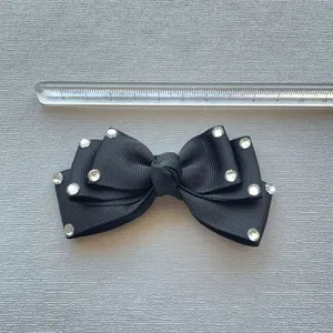 Black ribbed fabric 3D bow hair clip with clear rhinestones and 10.5cm scale reference