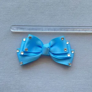 Detail of light blue grosgrain ribbon bow with rhinestones measuring 8.5 cm wide