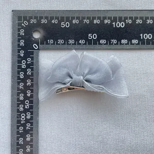 Blue organza mesh bow hair clip for girls, size 8.5x4.5cm shown with a ruler