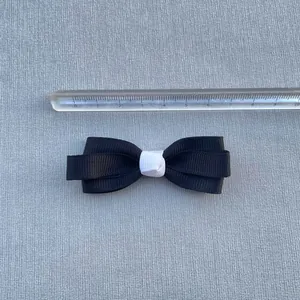 Macro view of a 5.5cm black and white handmade ribbon bow for DIY hair accessories