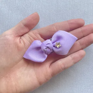 Close-up of light purple ribbed grosgrain ribbon bow with a crystal star embellishment