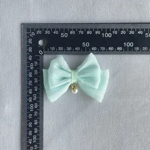 Mint green tulle bow hair accessory with pearl pendant and size measurements