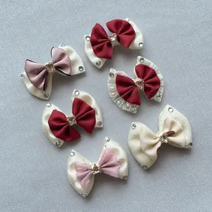 Detail of assorted handmade satin bows with crystal heart centers and lace accents