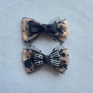 Detailed macro of handmade vintage bow accessories with floral lace and ribbon textures
