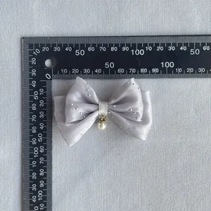 Grey satin bow with silver rhinestones and white pearl pendant measured by ruler