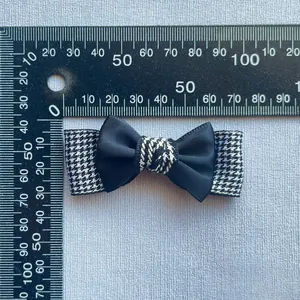 Handmade black satin and houndstooth bow hair clip with measurement ruler
