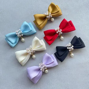 Detailansicht handgefertigter Satin-Schleifen-Clips mit Perlenanhängern in sechs Farben