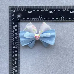 Measurement photo showing 75mm blue floral ribbon bow with pink strawberry charm