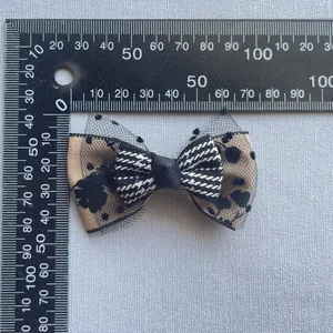 Handmade leopard print and houndstooth fabric bow with polka dot mesh for DIY accessories