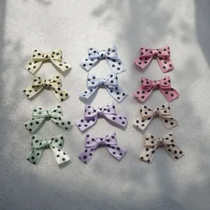 Close-up of colorful polka dot ribbon bows for DIY crafts and doll accessories