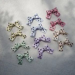 Detailed view of colorful polka dot ribbon bows for DIY crafts and hair accessories