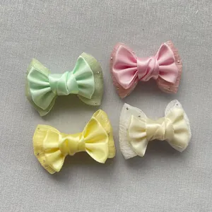 Detail of 6cm double-layered bow accessories with organza, satin and rhinestones