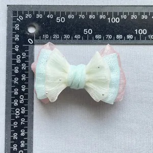 Dettaglio di fiocco in tessuto fai-da-te con glitter argento e misura di circa 90mm