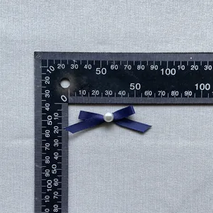 Dark blue ribbon bow with pearl center, measuring 3.5cm to 4cm for cake and DIY decor